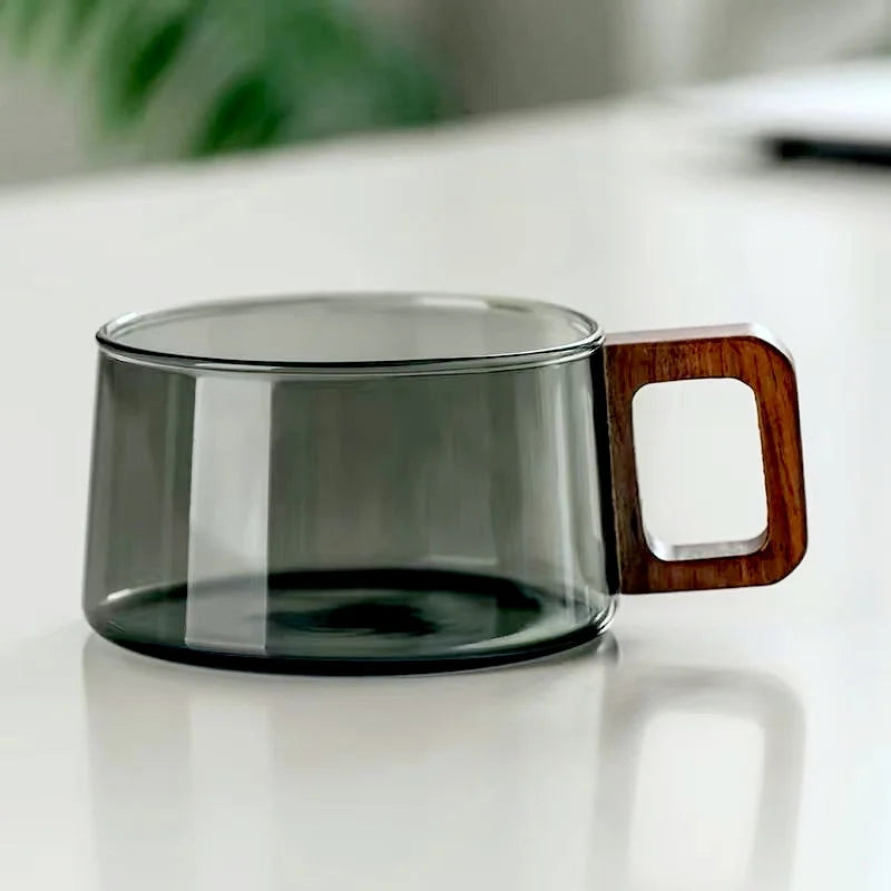 Elegant borosilicate glass tea cup with a distinctive wooden handle, a thoughtful gift for drink lovers.