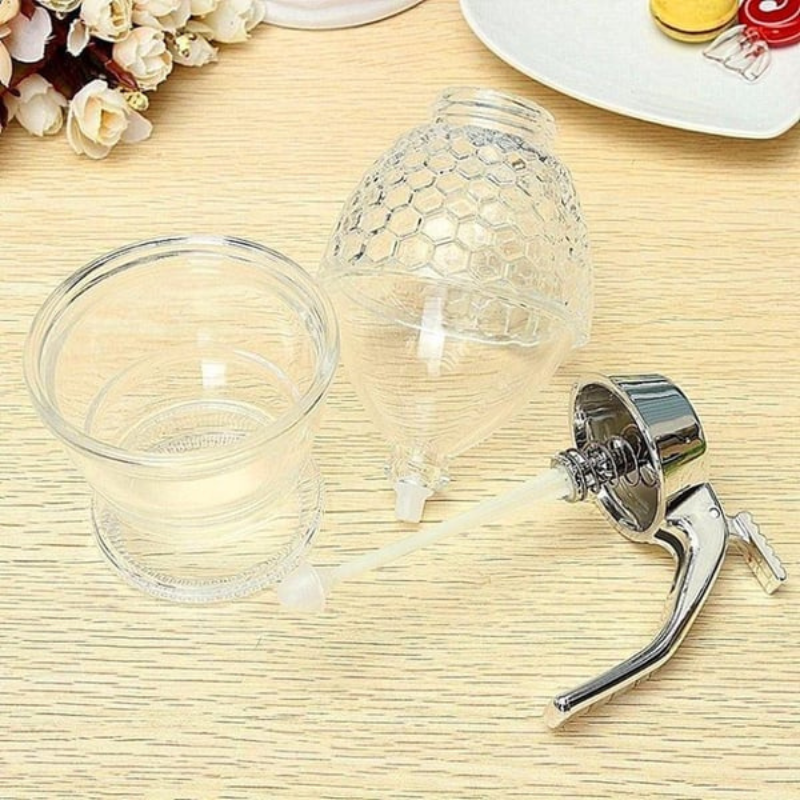 Modern clear plastic honey dispenser, keeps tables clean and sticky-free while serving.