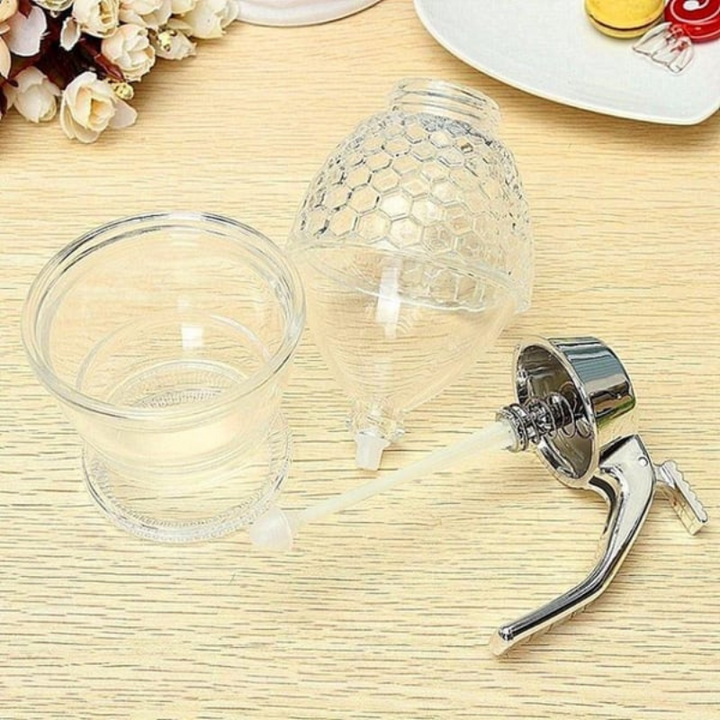 Modern clear plastic honey dispenser, keeps tables clean and sticky-free while serving.