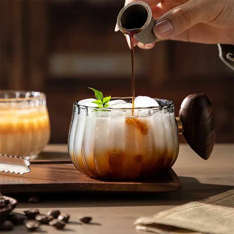 Clear textured borosilicate glass mug with natural wood handle, 8 fl oz.