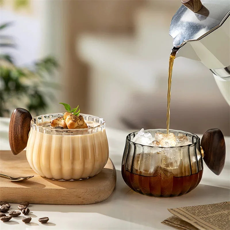 Stylish black tint glass coffee mug with comfortable wooden handle, perfect for hot or cold drinks.