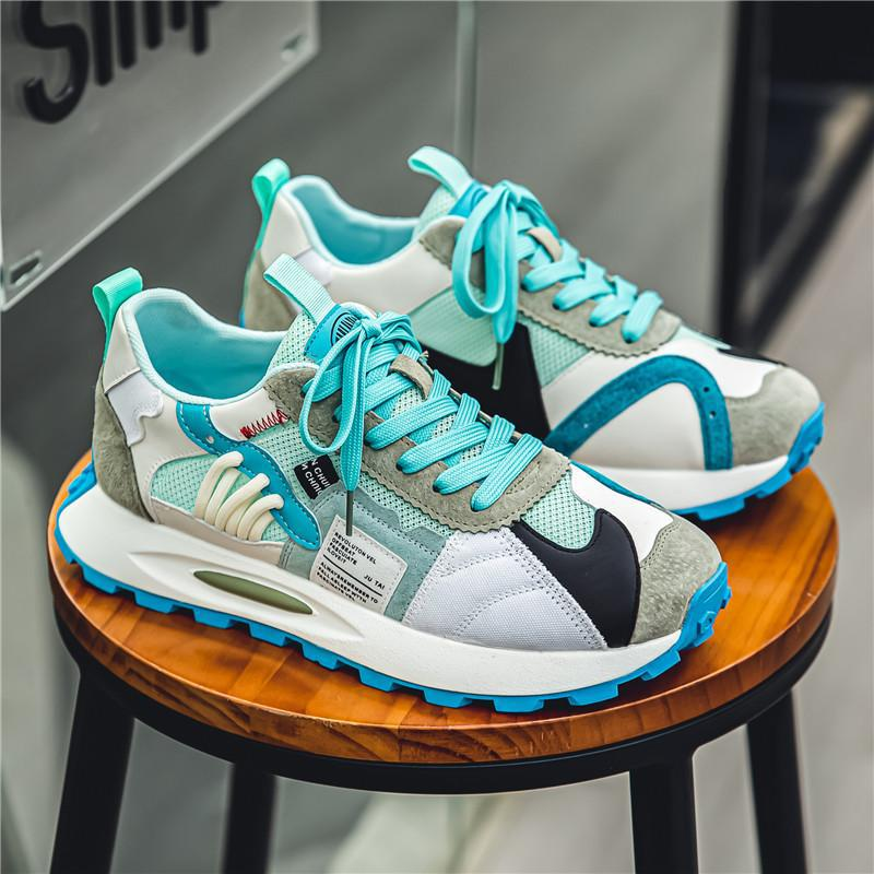 Close-up multicolor mens retro athletic sneakers, lace-up, perfect for Y2K streetwear.