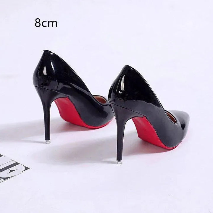 Pair of classic black stiletto pumps, versatile elegant high heels for women's formal occasions.