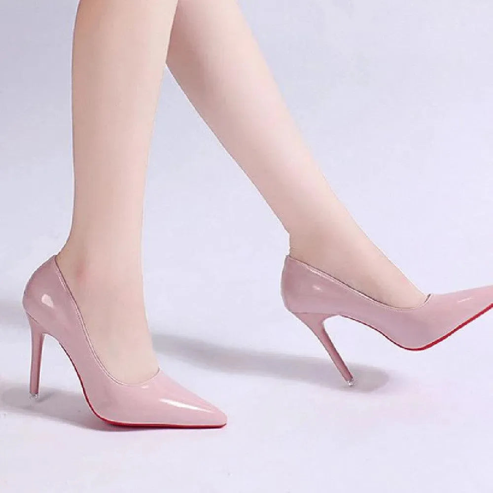 Detail of the pointed toe and stiletto heel of a classic black women's pump.
