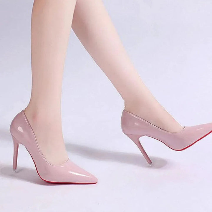 Detail of the pointed toe and stiletto heel of a classic black women's pump.