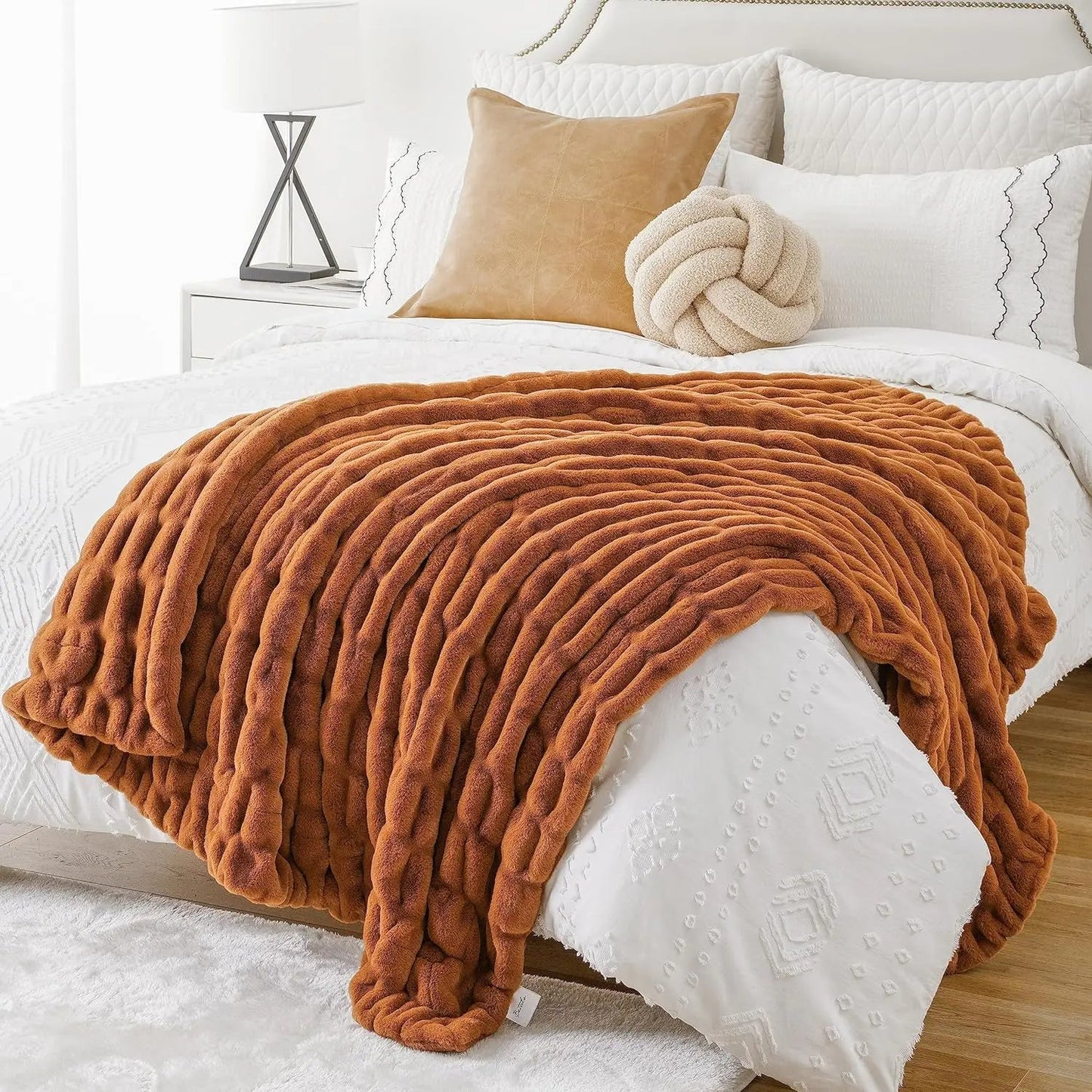 Decorative soft blanket made of luxurious faux rabbit fur, enhancing a stylish living area.