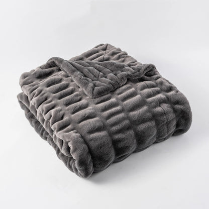 Cozy soft faux fur blanket, providing a plush, warm, & decorative touch to home interiors.