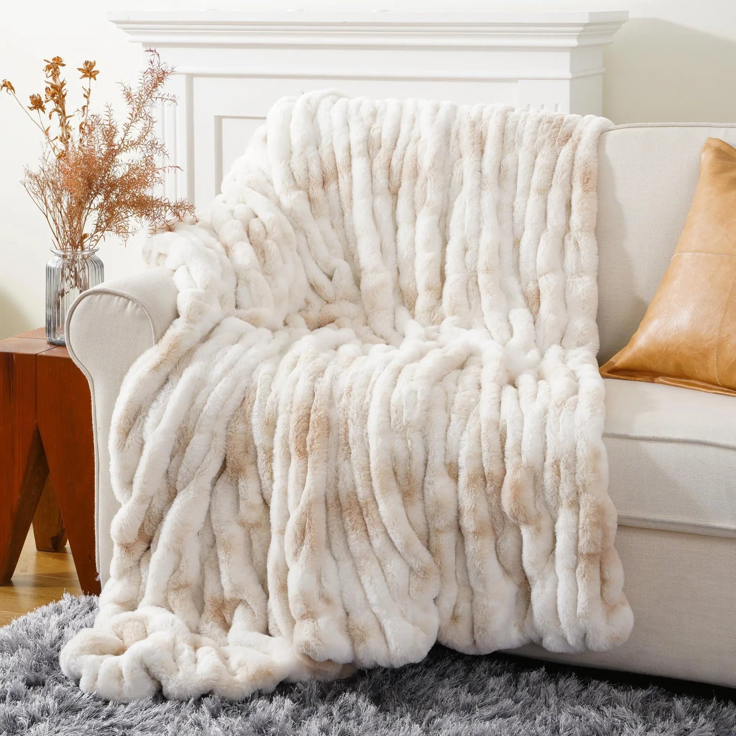 Decorative faux fur throw blanket in a neutral tone, ideal for stylish home decor & comfort.