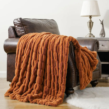 High-quality faux fur throw blanket, showcasing its plush pile & elegant decorative appeal.