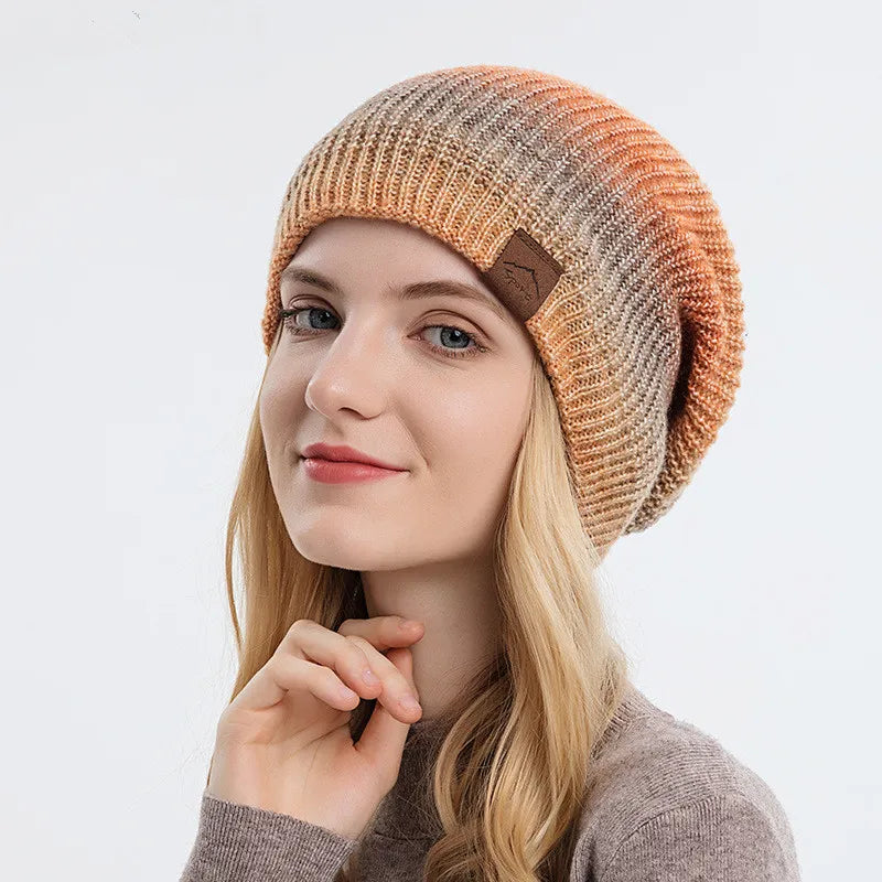 Colorful rainbow knit beanie hat, perfect for unisex winter style & warmth.