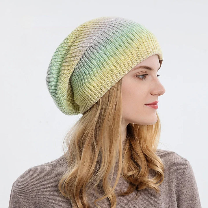 Warm knit rainbow beanie hat, a cozy winter accessory with stretch fit.