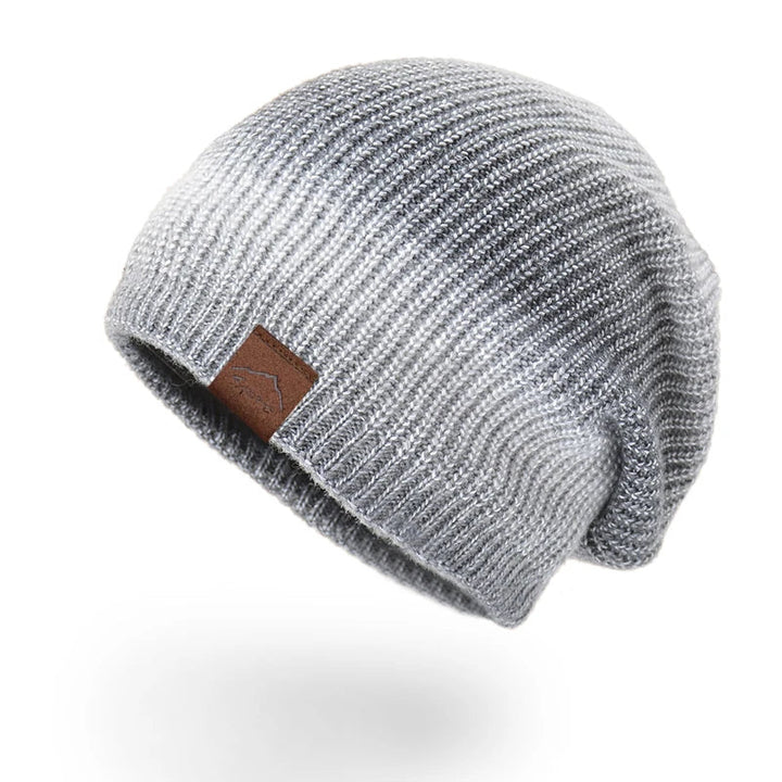 Vibrant rainbow knit beanie hat, ideal for adding a pop of color to winter fashion.