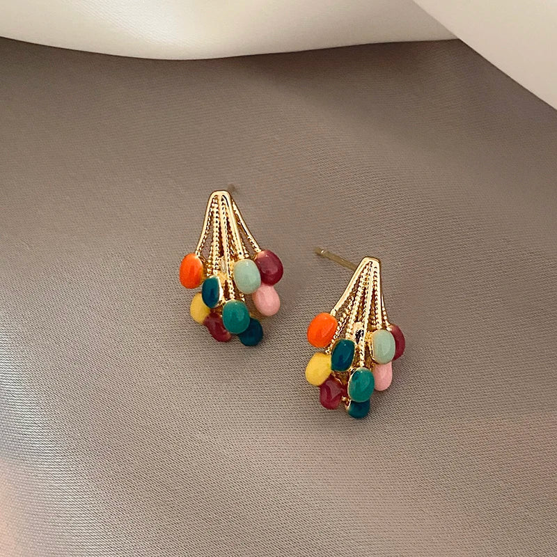 Playful statement stud earrings for women. Colorful enamel balloon cluster design with a chic gold-tone finish.