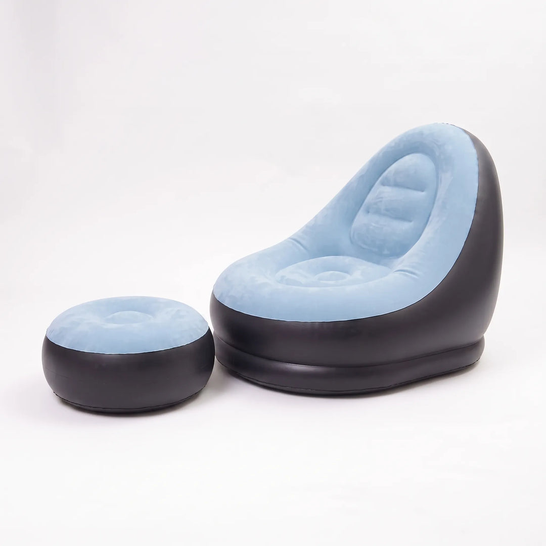 Person relaxing on a comfortable inflatable lounge chair with footrest on a patio, enjoying leisure.
