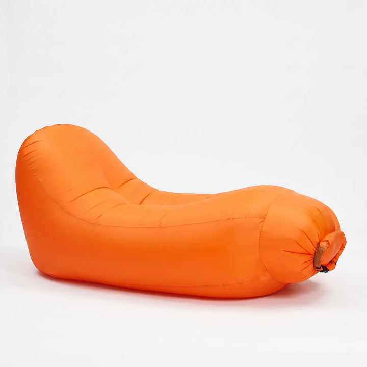 Durable inflatable beach chair, a portable air lounger ideal for camping, picnics, or park relaxation.