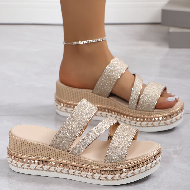 Stylish beige flat slip-on sandals for women, featuring soft straps for comfortable casual summer wear.