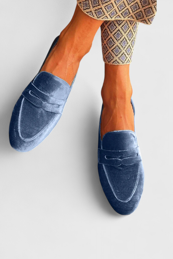 Women's flat blue slip-on loafers, ideal for comfortable everyday wear, casual outfits, or work attire.