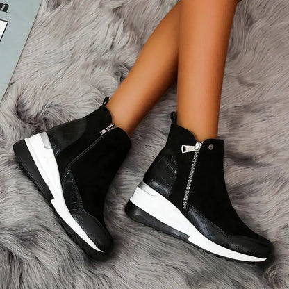 Chic women's ankle boots with a comfortable wedge heel and practical side zipper closure.