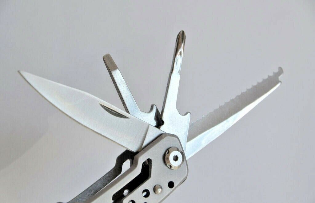 Multitool on a wooden surface, ready for camping, hiking, or everyday utility