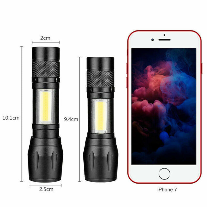Tactical flashlight, 900lm USB rechargeable, next to camping equipment