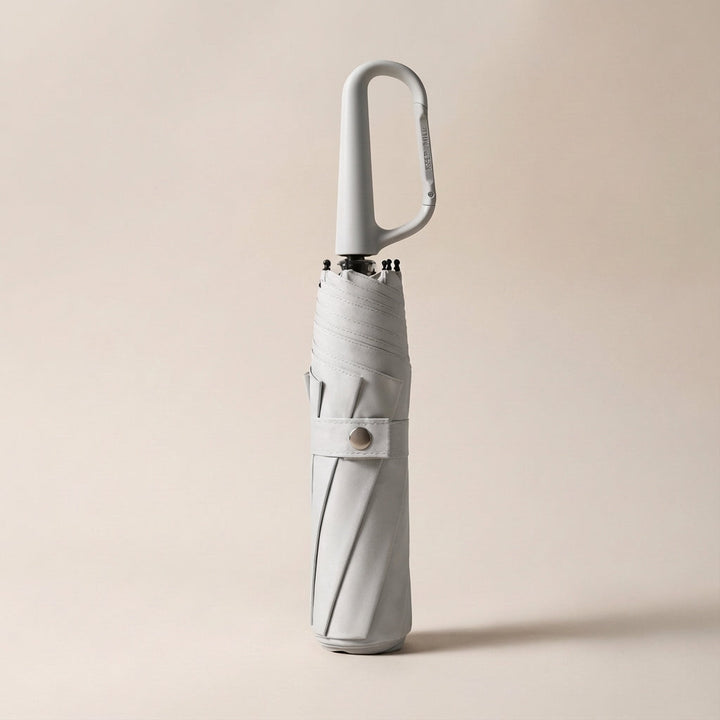 Lightweight unisex travel umbrella with a robust clip, offering protection from rain and harmful UV rays.
