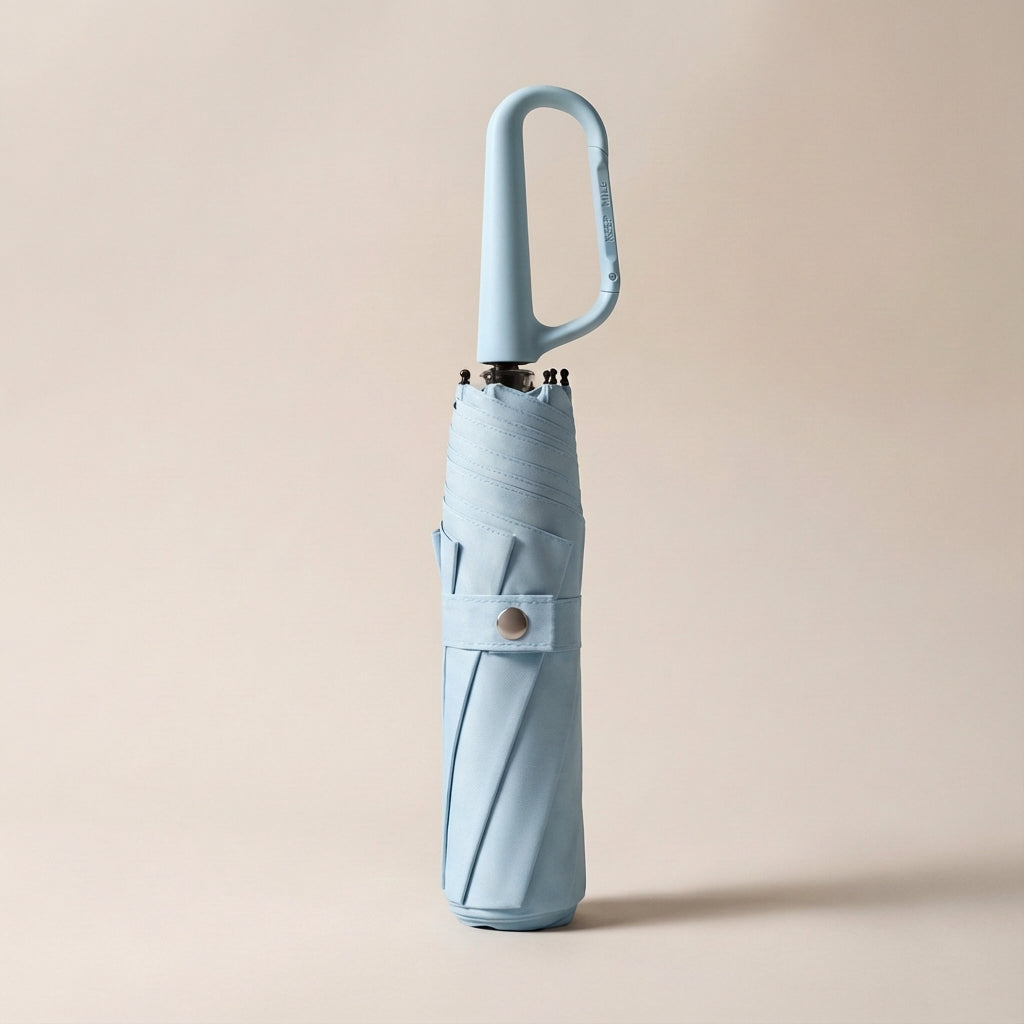 Sleek compact umbrella demonstrating its easy-fold mechanism and secure clip for ultimate portability.