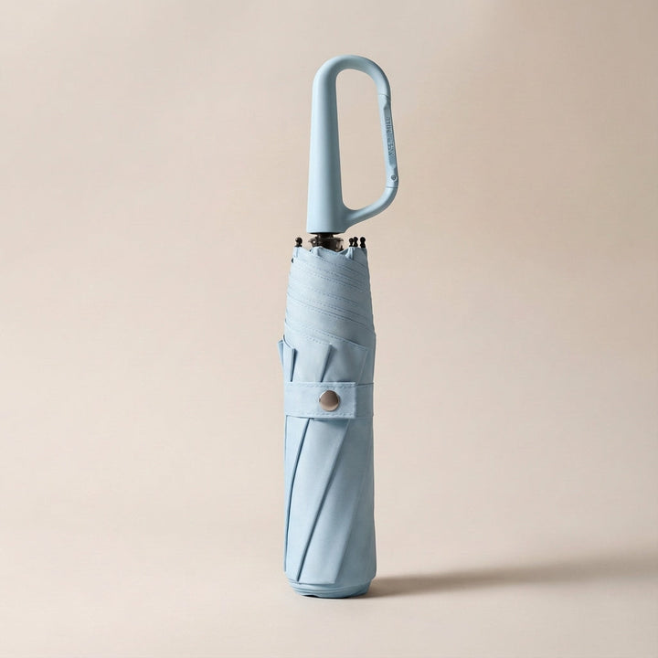 Sleek compact umbrella demonstrating its easy-fold mechanism and secure clip for ultimate portability.