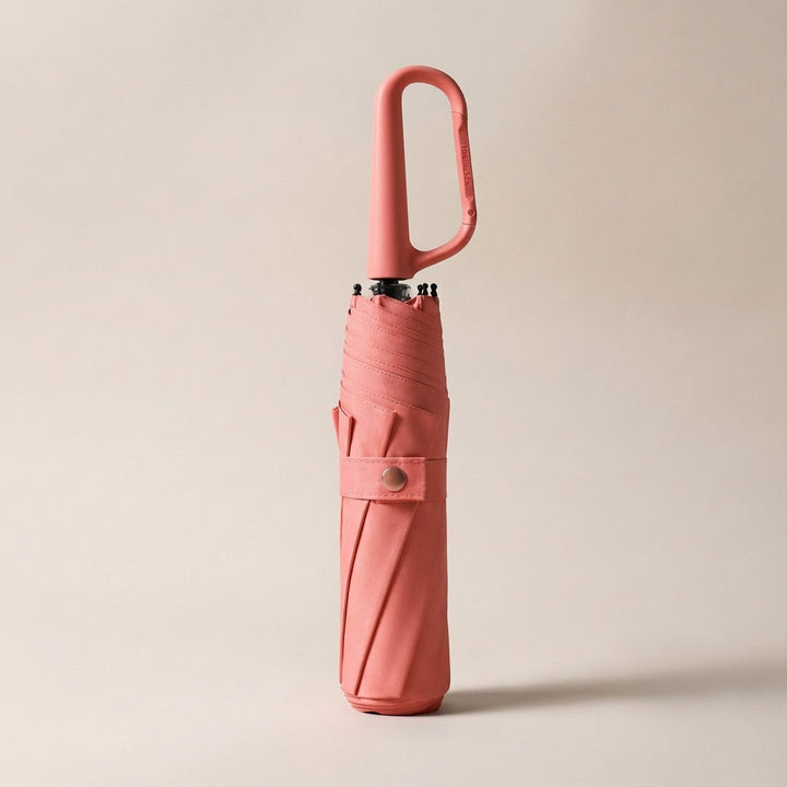 Waterproof UV protection umbrella, compact and foldable, shown with its practical clip-on feature.