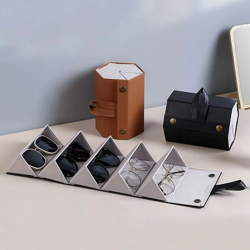Compact black leather multi-slot roll-up glasses case, perfect for organizing and protecting eyewear during travel.