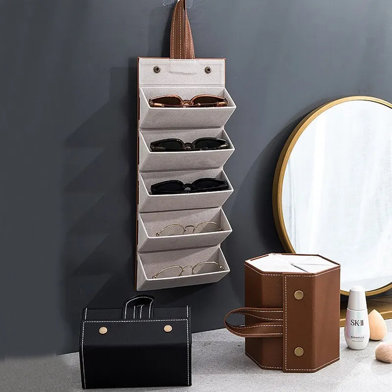 Unrolled brown leather multi-slot eyewear holder, showcasing individual compartments for sunglasses and reading glasses.