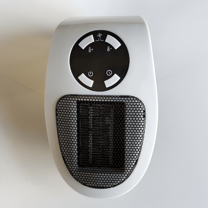 Portable electric space heater warming an office desk. Compact mini heater for personal warmth in cubicles or workstations.