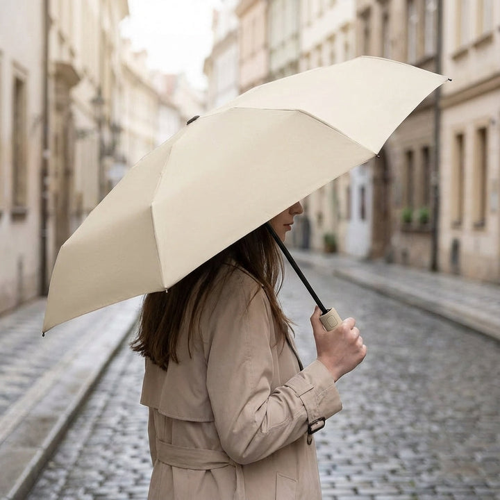 Compact, foldable travel umbrella, lightweight & portable for easy carrying.
