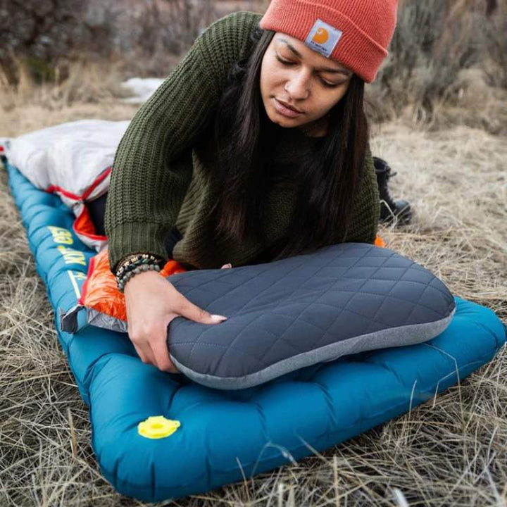 Compact inflatable camping pillow in blue, perfect for travel & outdoor sleeping comfort