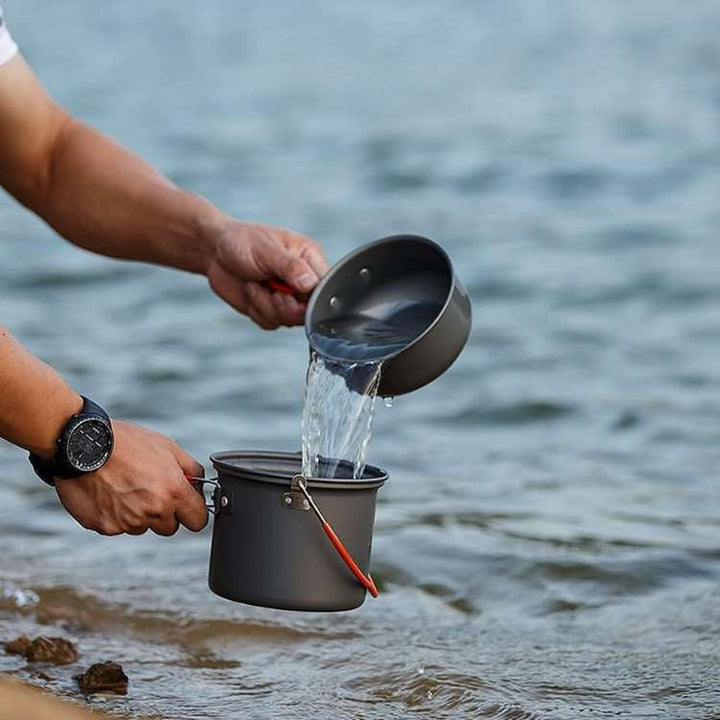 Compact camping cooking system, includes pot, pan, and lid, perfect for outdoor adventures