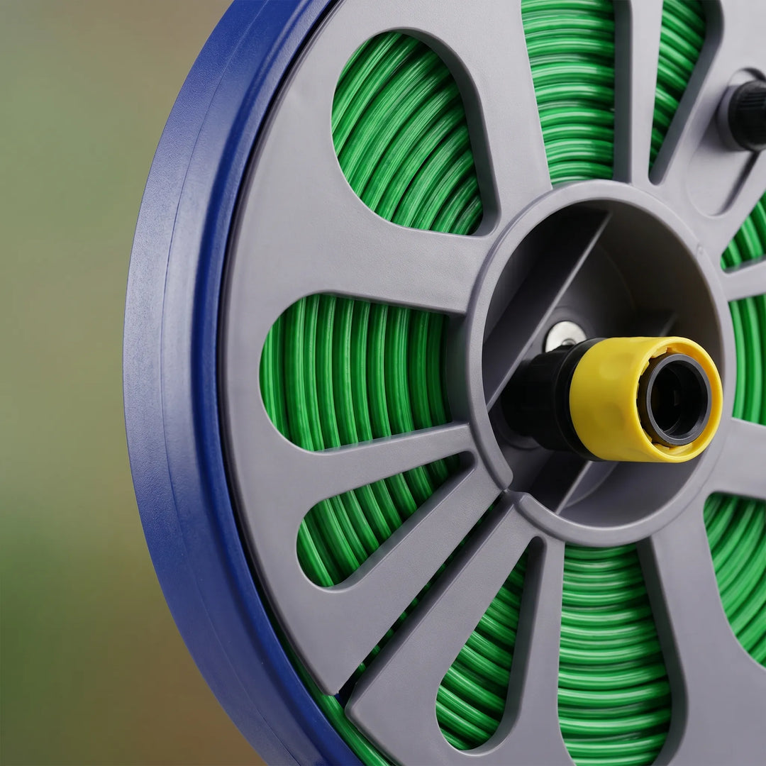 Efficient watering tool: compact garden hose reel with quick connect for convenient outdoor watering.