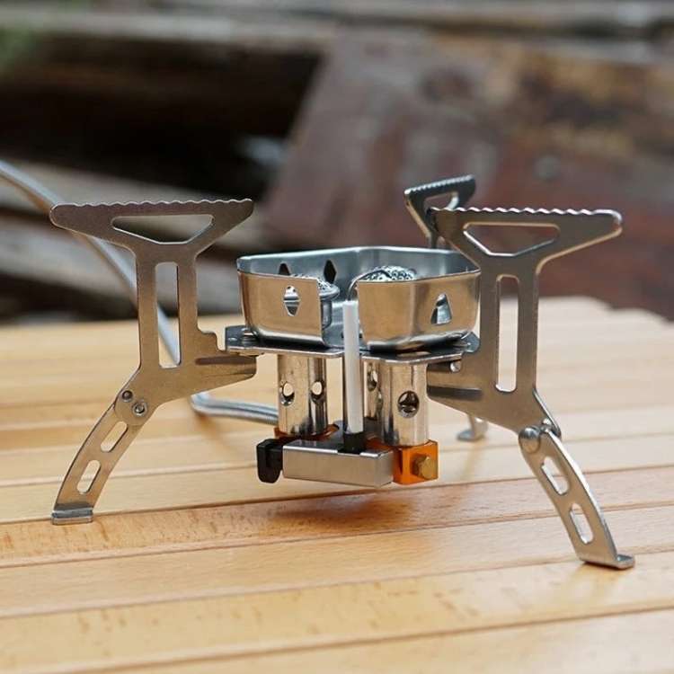 Compact portable propane gas camping stove with single burner, perfect for outdoor cooking and backpacking.