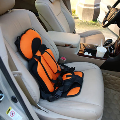 Folded compact child car seat next to a suitcase, demonstrating ultimate portability for travel.