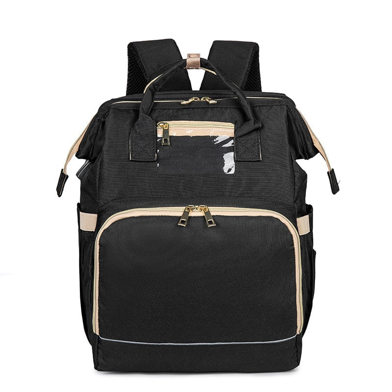 Portable baby bassinet and changing station unfolded from a stylish multi-pocket diaper backpack.
