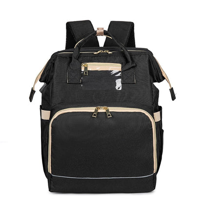 Portable baby bassinet and changing station unfolded from a stylish multi-pocket diaper backpack.
