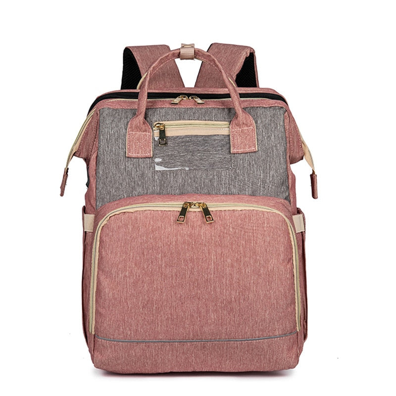 Parent comfortably carrying a stylish baby diaper backpack that converts to a portable bassinet.