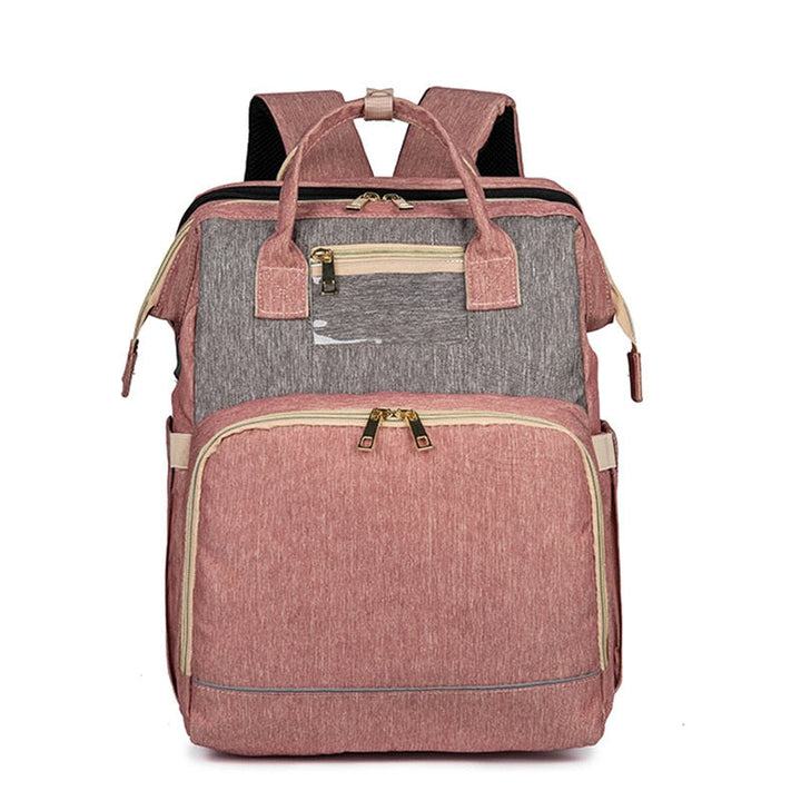Parent comfortably carrying a stylish baby diaper backpack that converts to a portable bassinet.