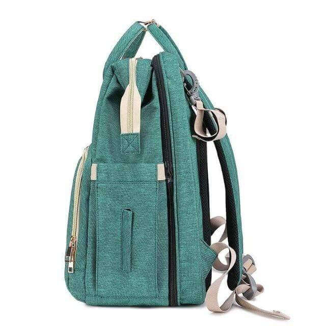 Diaper bag transforming into a convenient travel bassinet & changing pad for on-the-go parents.