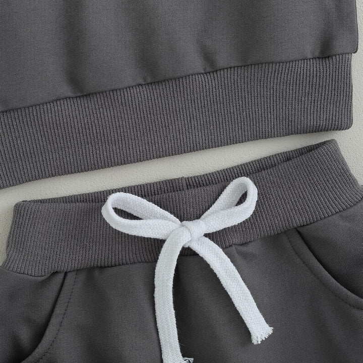 Thoughtfully designed baby winter jogger, contrast sweatshirt & practical trousers.