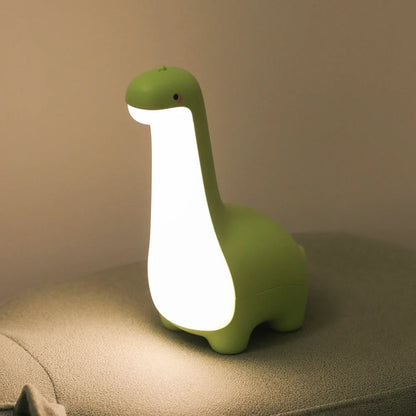 Soft silicone LED dinosaur night light. Gentle glow for nursery & kids' room decor. Rechargeable.