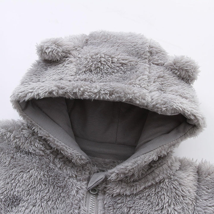 Cute hooded infant jumpsuit, fleece for warmth; essential baby winter outfit.