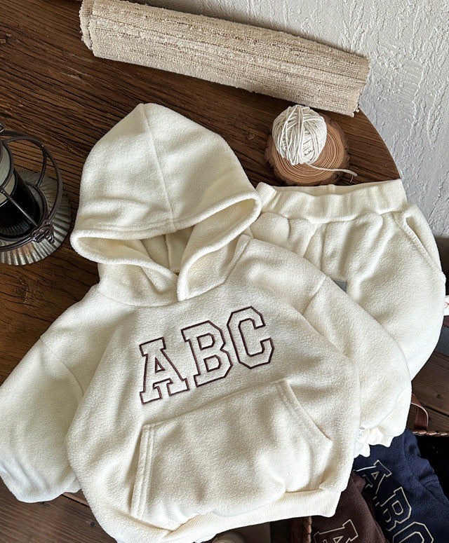 Warm two-piece children's winter outfit for active play. Soft fur-lined hoodie & pants for toddlers & kids.