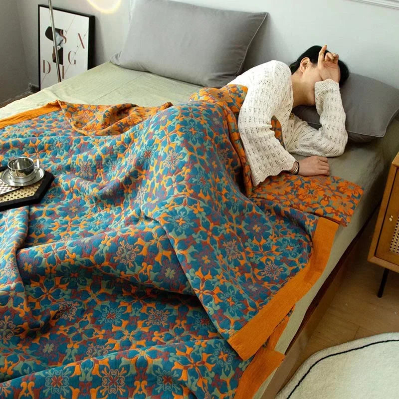 Eco-friendly six-layer cotton quilt with a cozy orange and blue reversible pattern for bedroom decor.