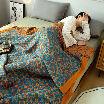 Eco-friendly six-layer cotton quilt with a cozy orange and blue reversible pattern for bedroom decor.