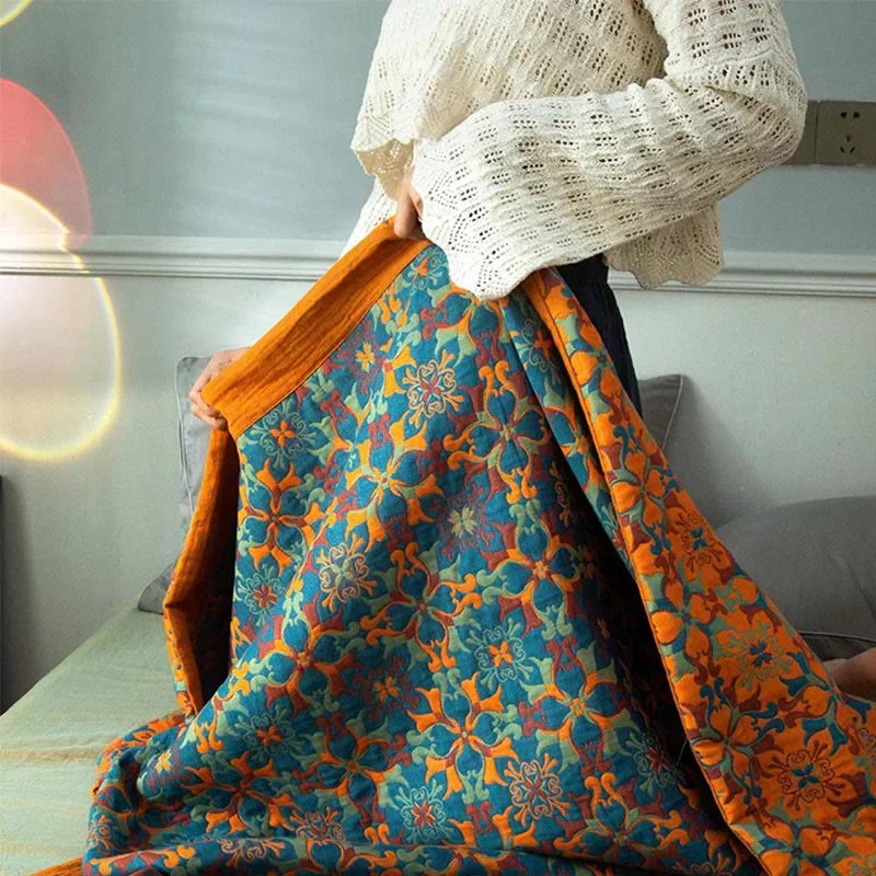 Vibrant orange & blue six-layer cotton quilt, reversible design enhances any home decor. Cozy and stylish.