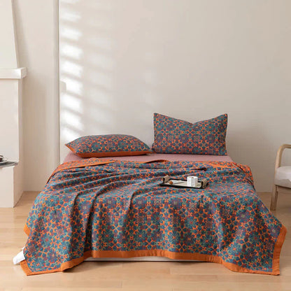 Reversible orange & blue cotton duvet quilt. Six-layer construction offers eco-friendly warmth & style.
